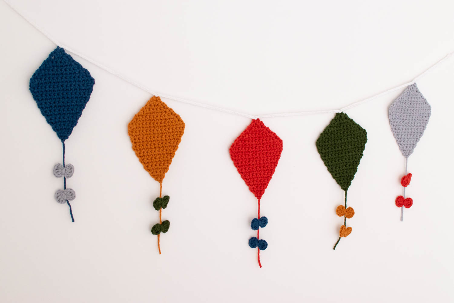 Crochet kite garland on wall